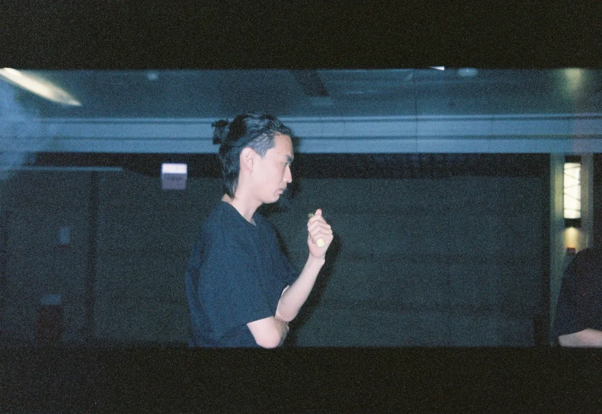 Film-grain portrait in a black tee