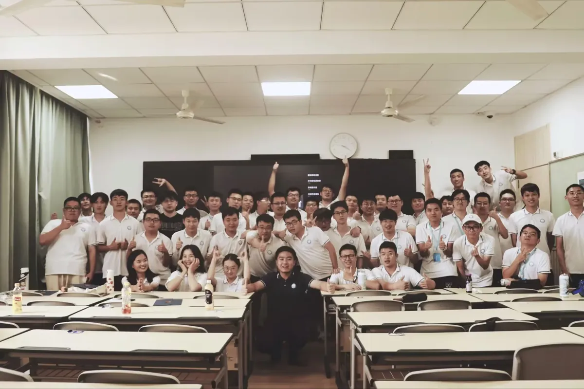 Group photo of a new-hire cohort in a classroom